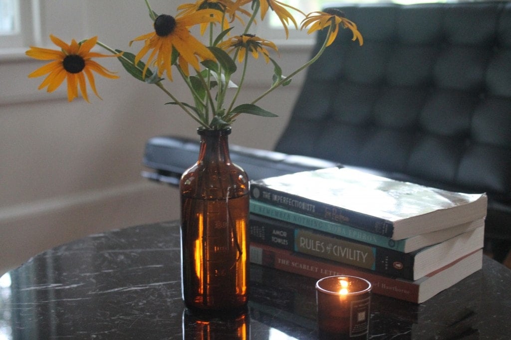 Black eyed susans and our latest stack of books.
