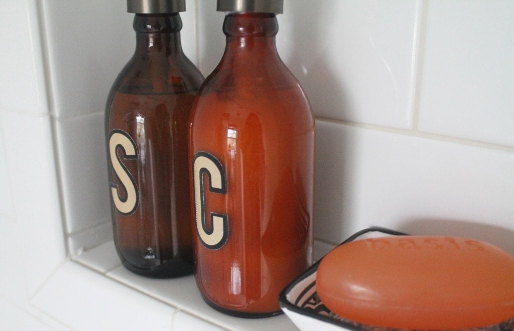 amber bottles repurposed for shampoo and conditioner with mailbox letters