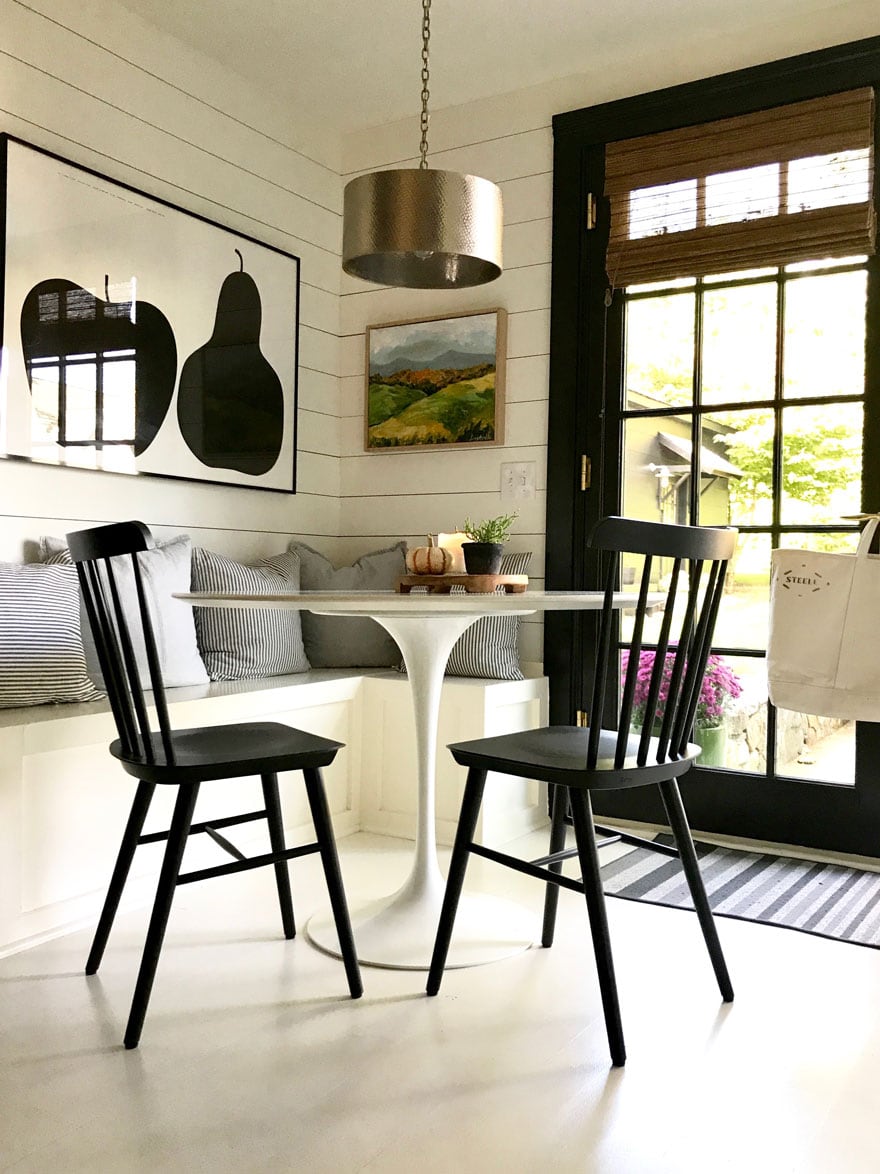 kitchen-nook-saarinen-table-black-and-white-shiplap-painted-floors