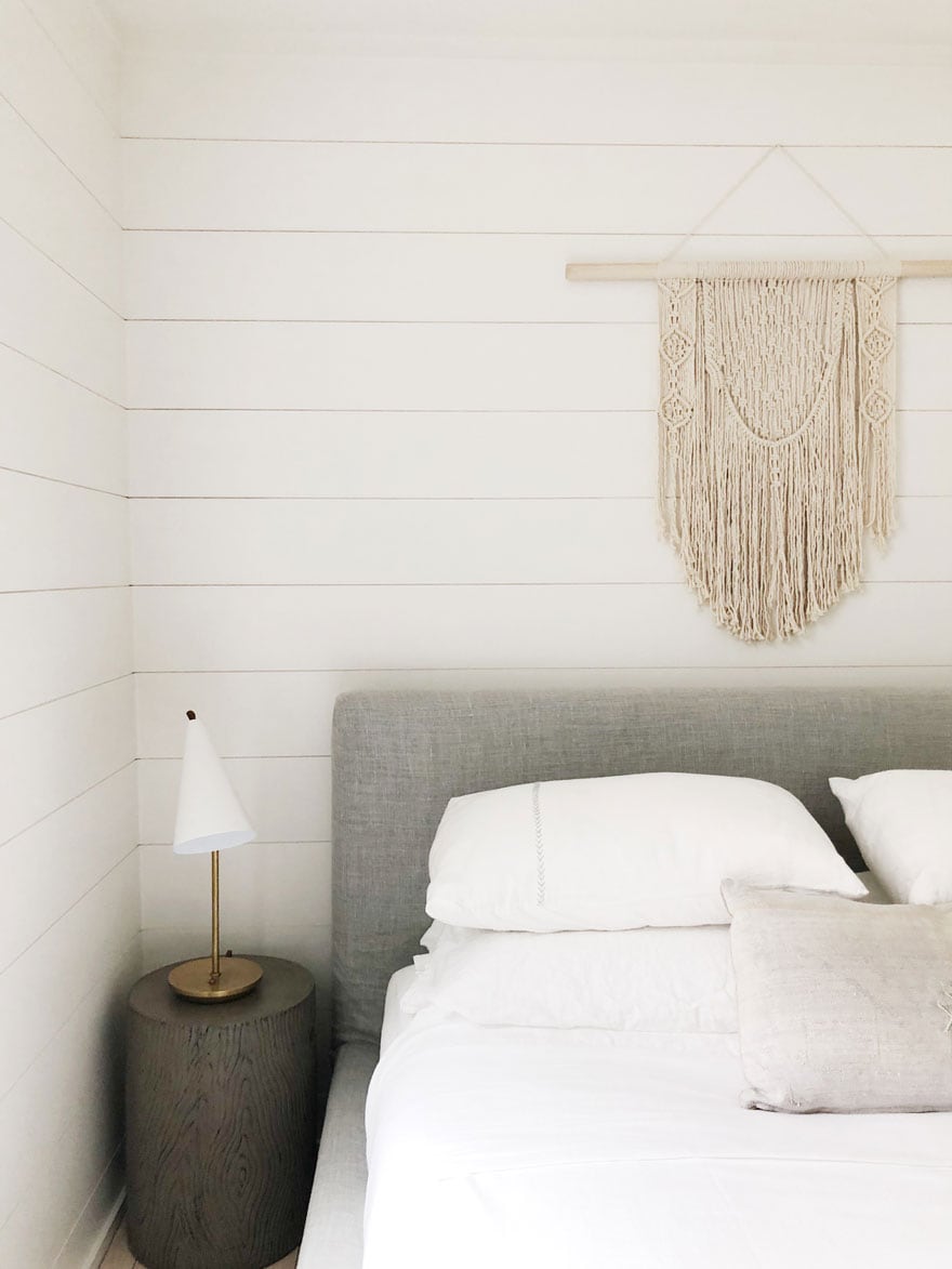 bed, macrame wall hanging