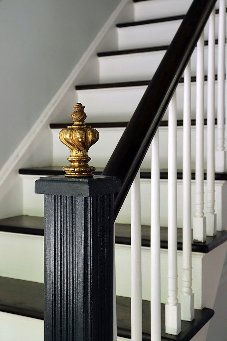 black newel post with brass finial