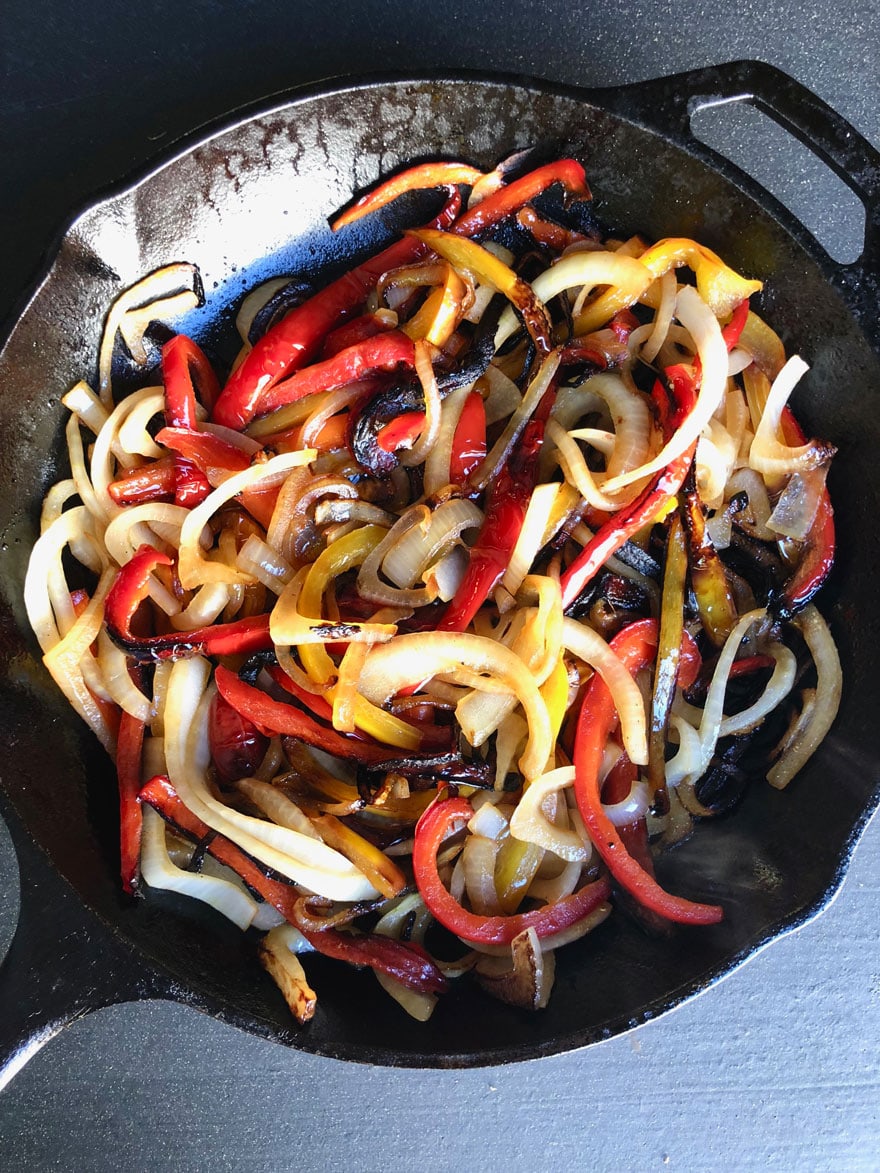 cooked peppers and onions in skillet