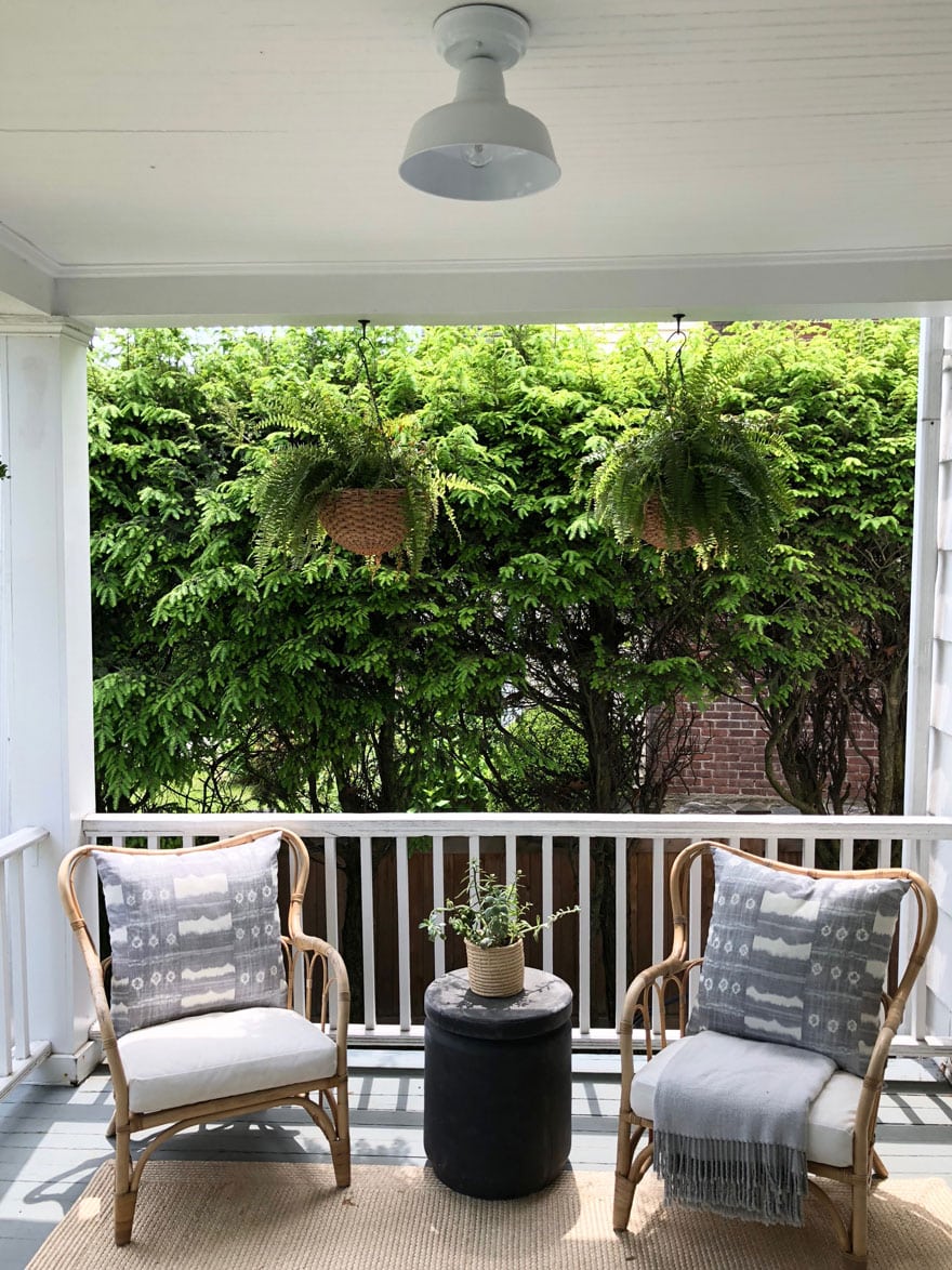 chairs on porch with hanging ferns