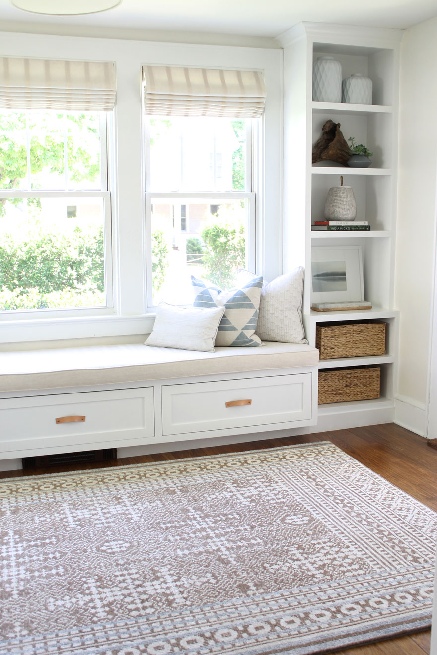 built in bench seat with cushion and book cases