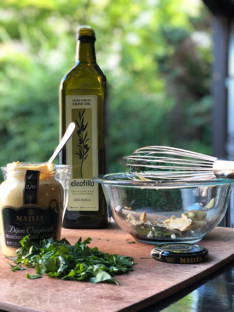 mustard, olive oil, bowl, whisk, fresh herbs