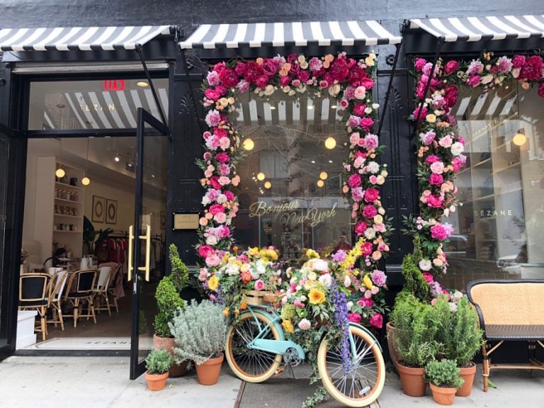 bike in front of shop window with flowers and plants
