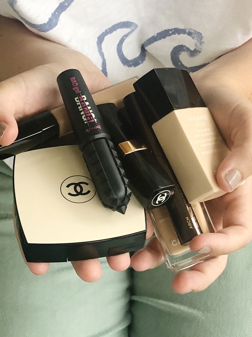 makeup products held in 2 hands