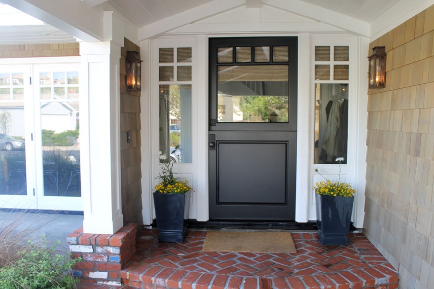 front porch with brick walk and planters and dutch door