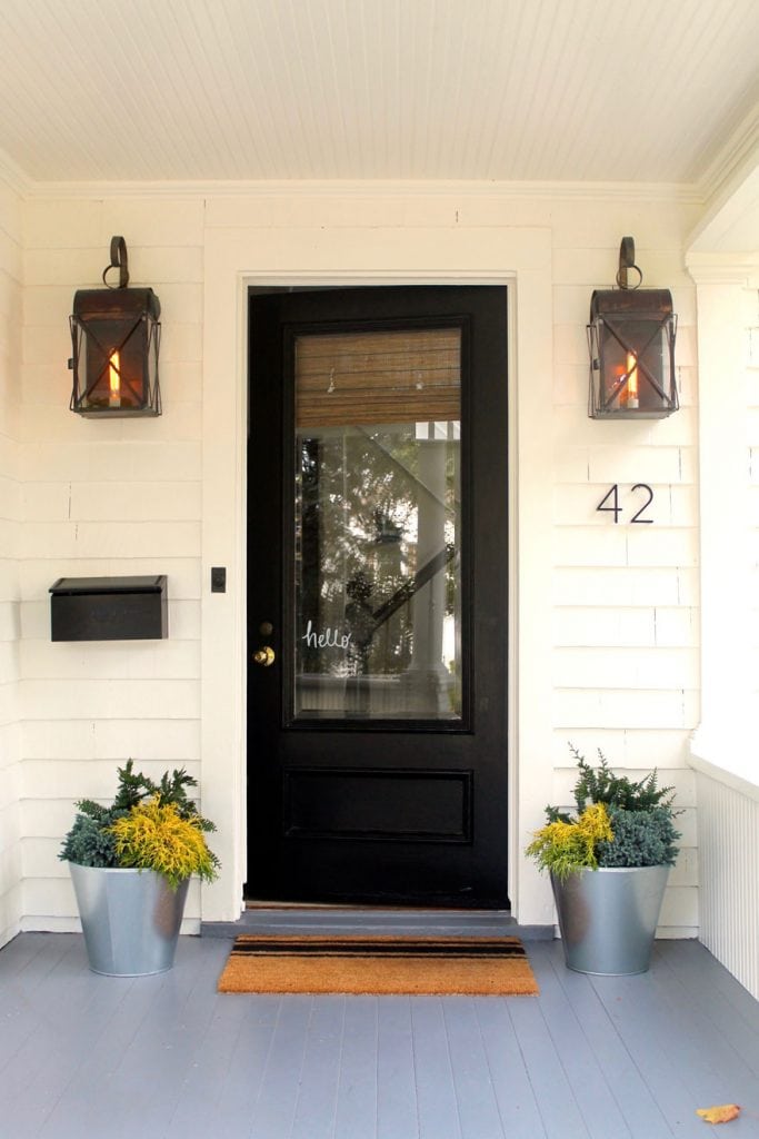 house with black door and planters
