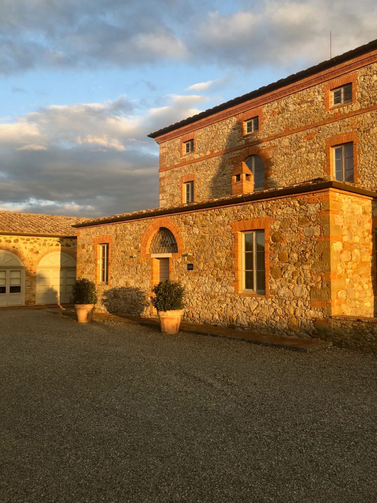Old stone buildings drenched in sunlight during the golden hour at Borgo Scopeto.