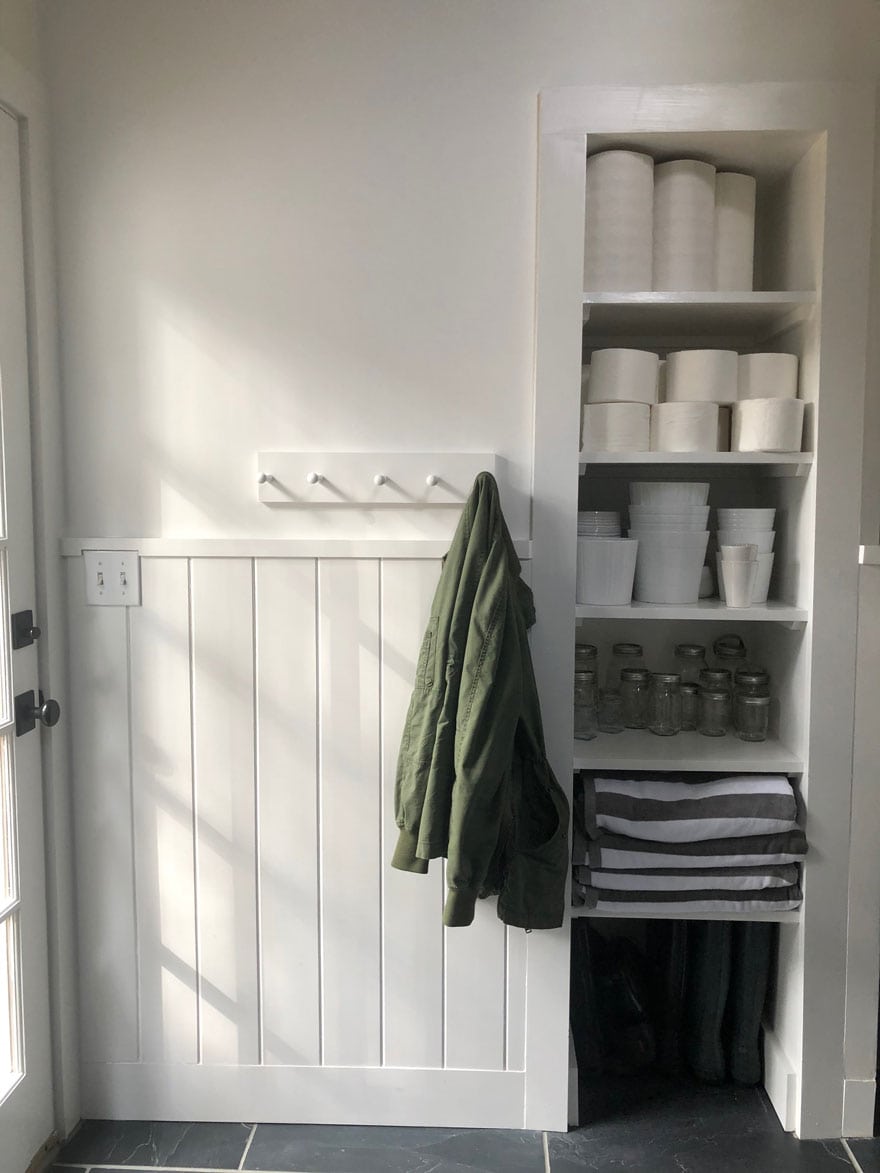 shelves with storage, green jacket on hook