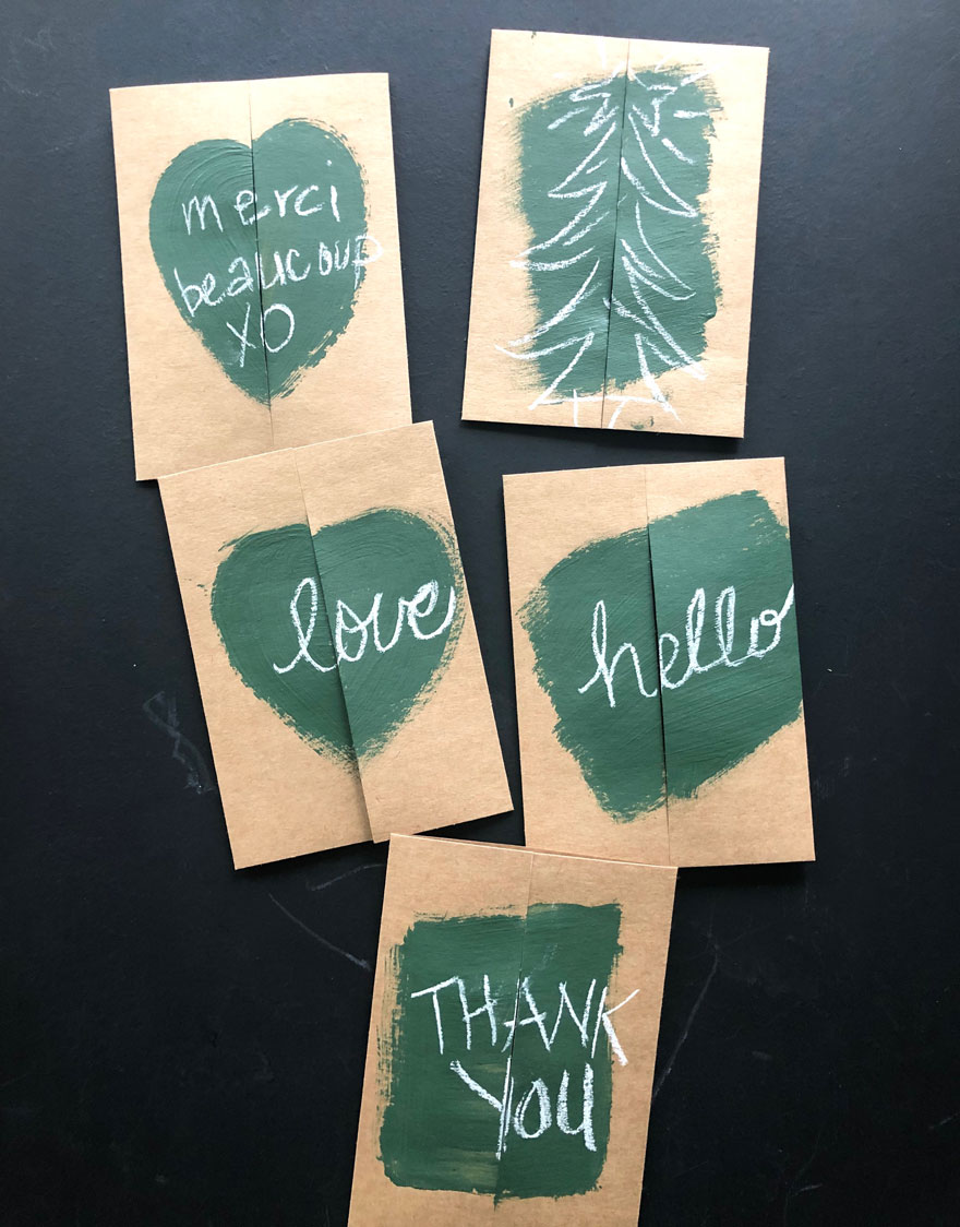 cards with green paint and words in chalk on black background