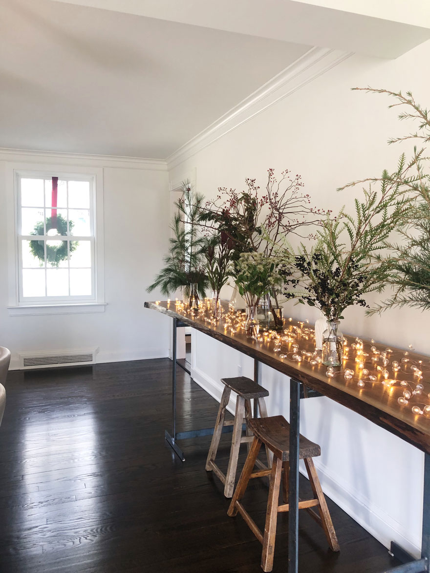 greens, vases, long table with window and wreath