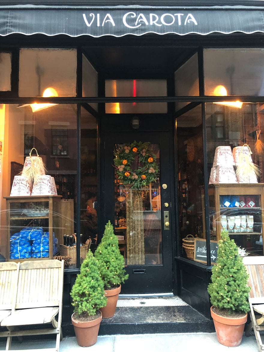 cafe window and door with small trees and wreath