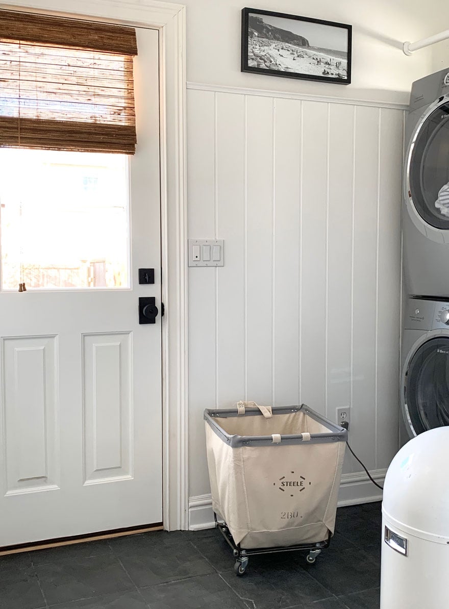 door with window and wood blind, laundry cart and washer and dryer