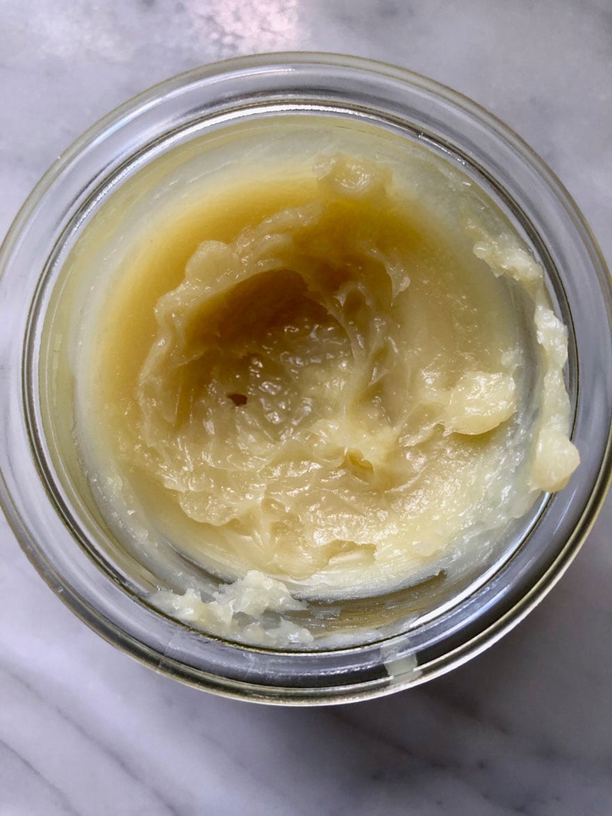 light yellow cream in glass jar 