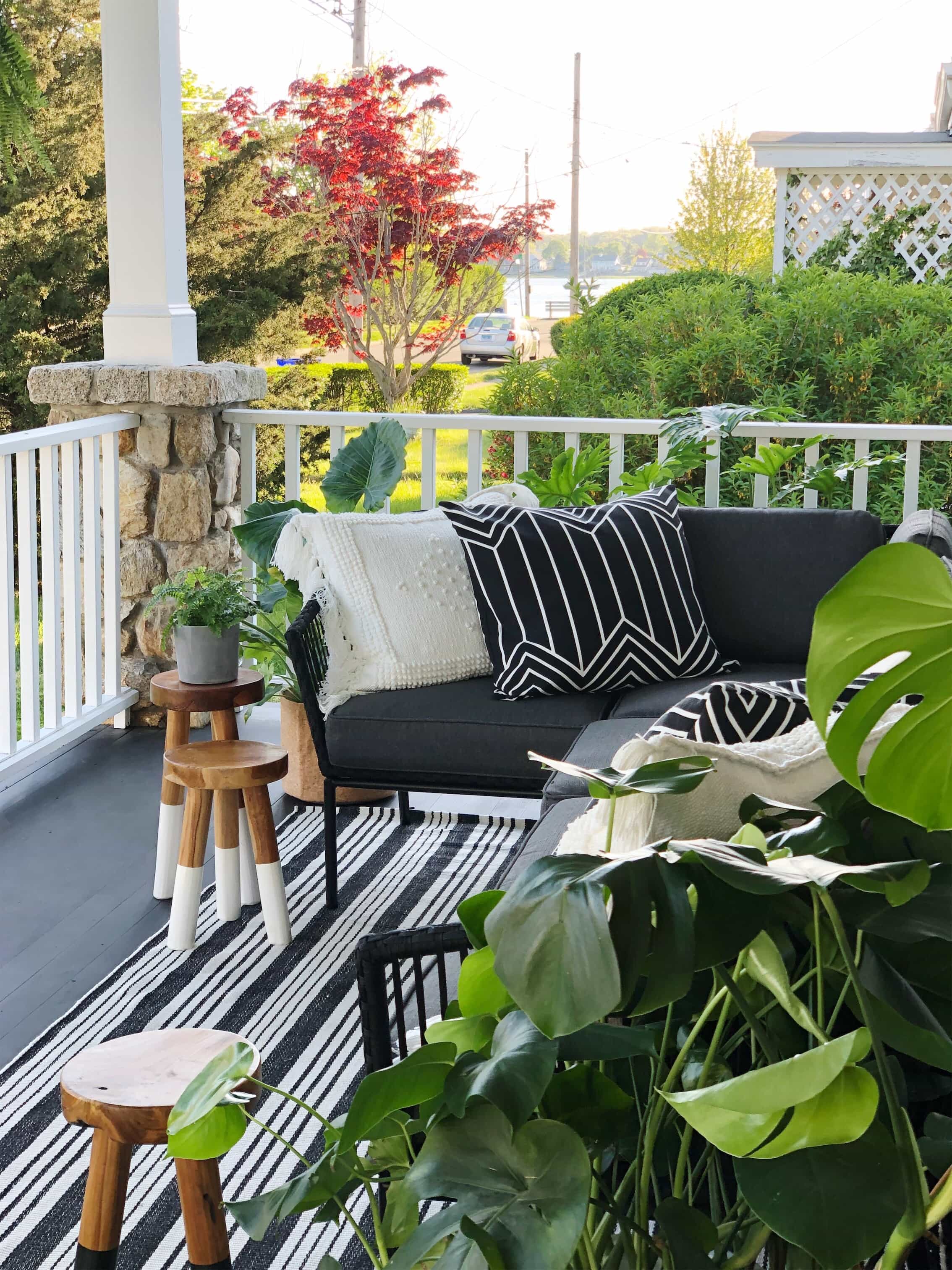 porch with pillows, stools, plants