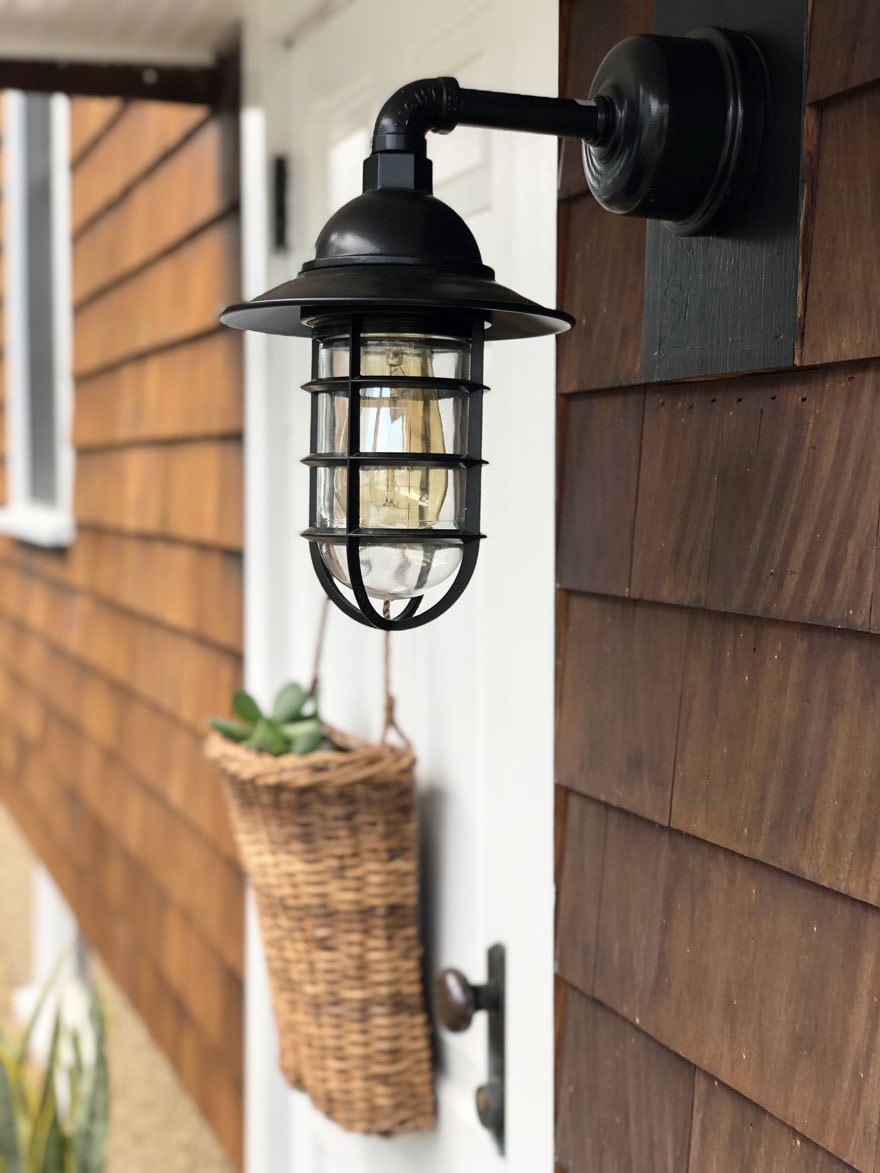 light on house with basket on door