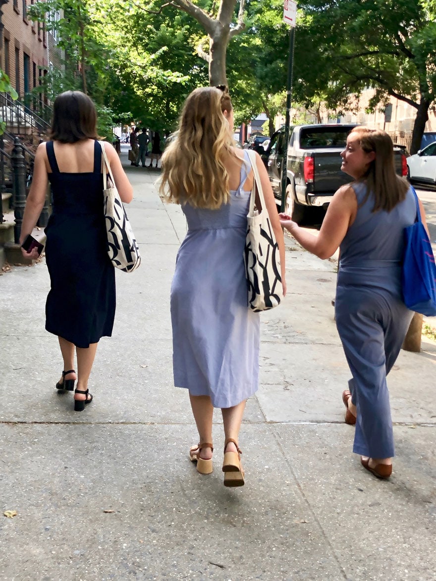 girls walking on a Brooklyn street with tote bags