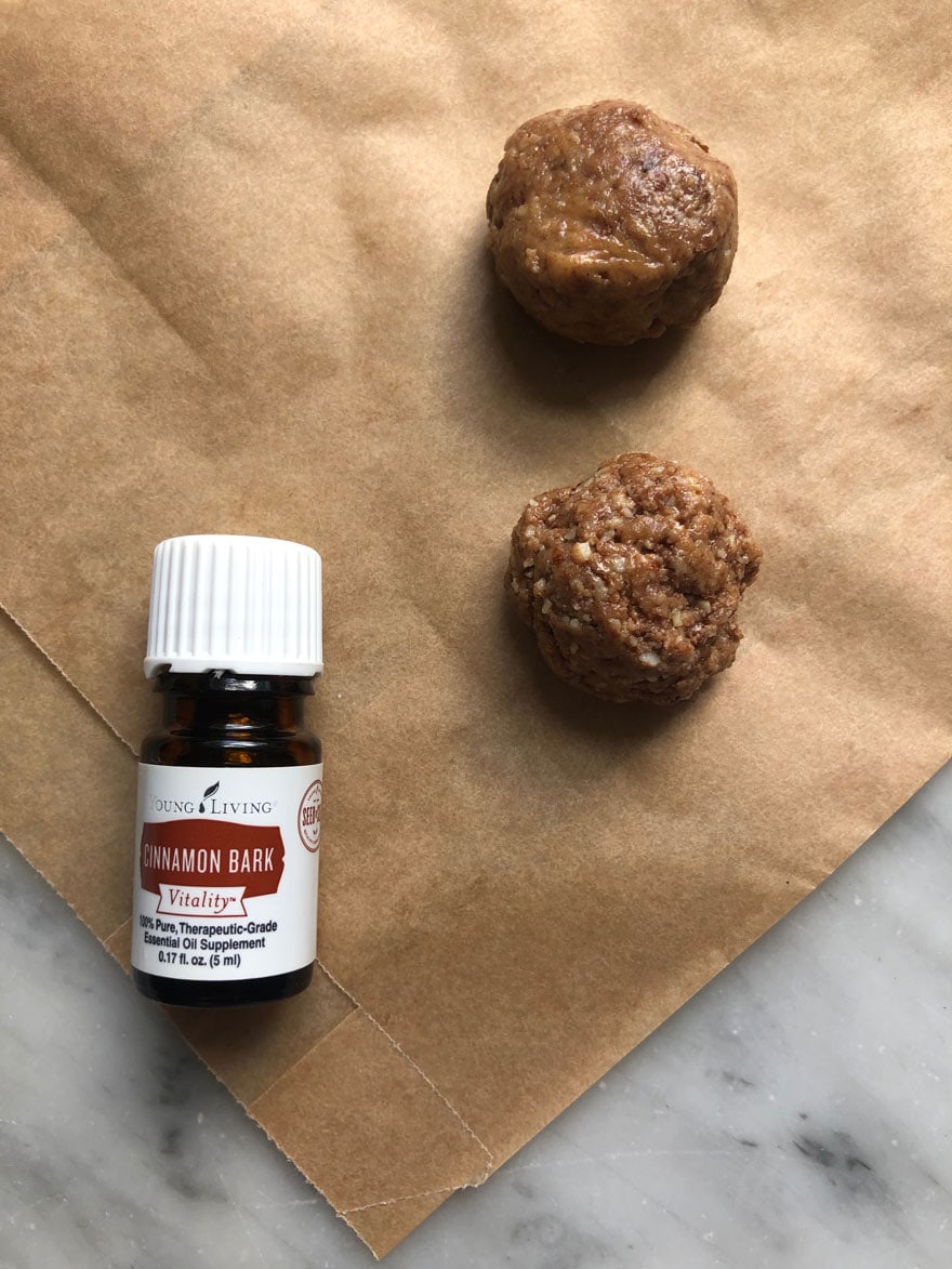 cookie balls and bottle of essential oil on parchment
