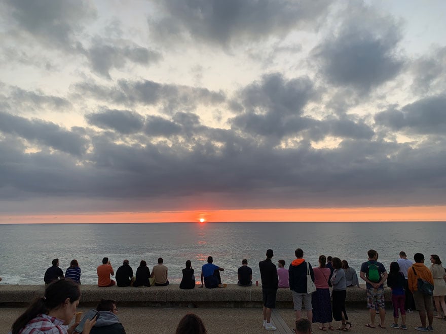 people watching sunset 