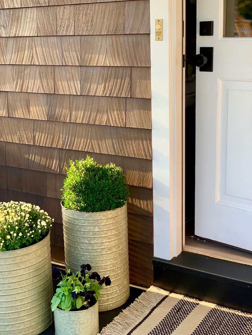 3 planters, white door with black door hardware