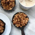 small skillets with apple and ice cream on marble