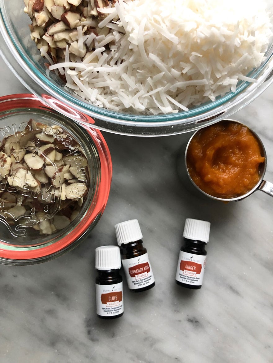 essential oil bottles, ingredients, bowls on marble counter