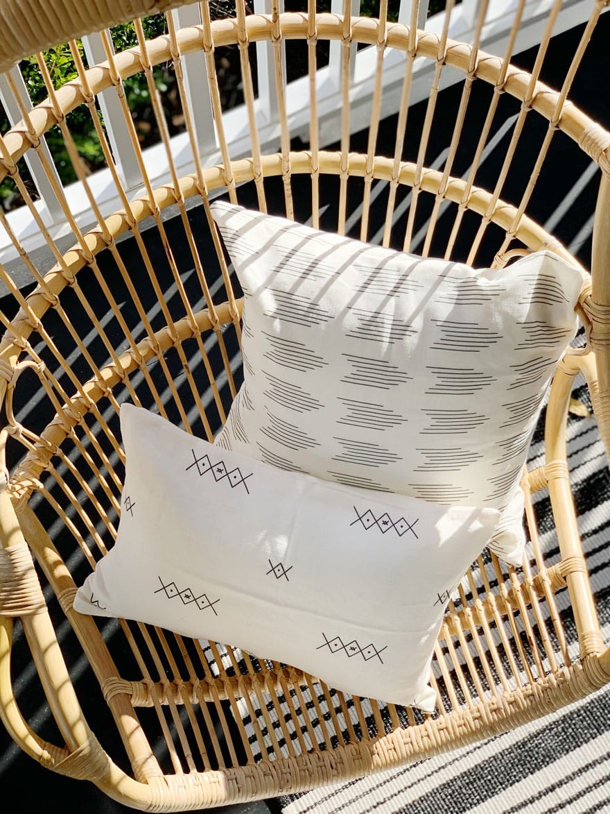 2 pillows on rattan hanging chair