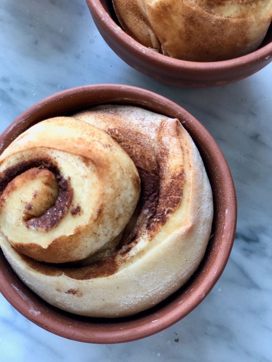 cinnamon bread in terra cotta pot on marble counter