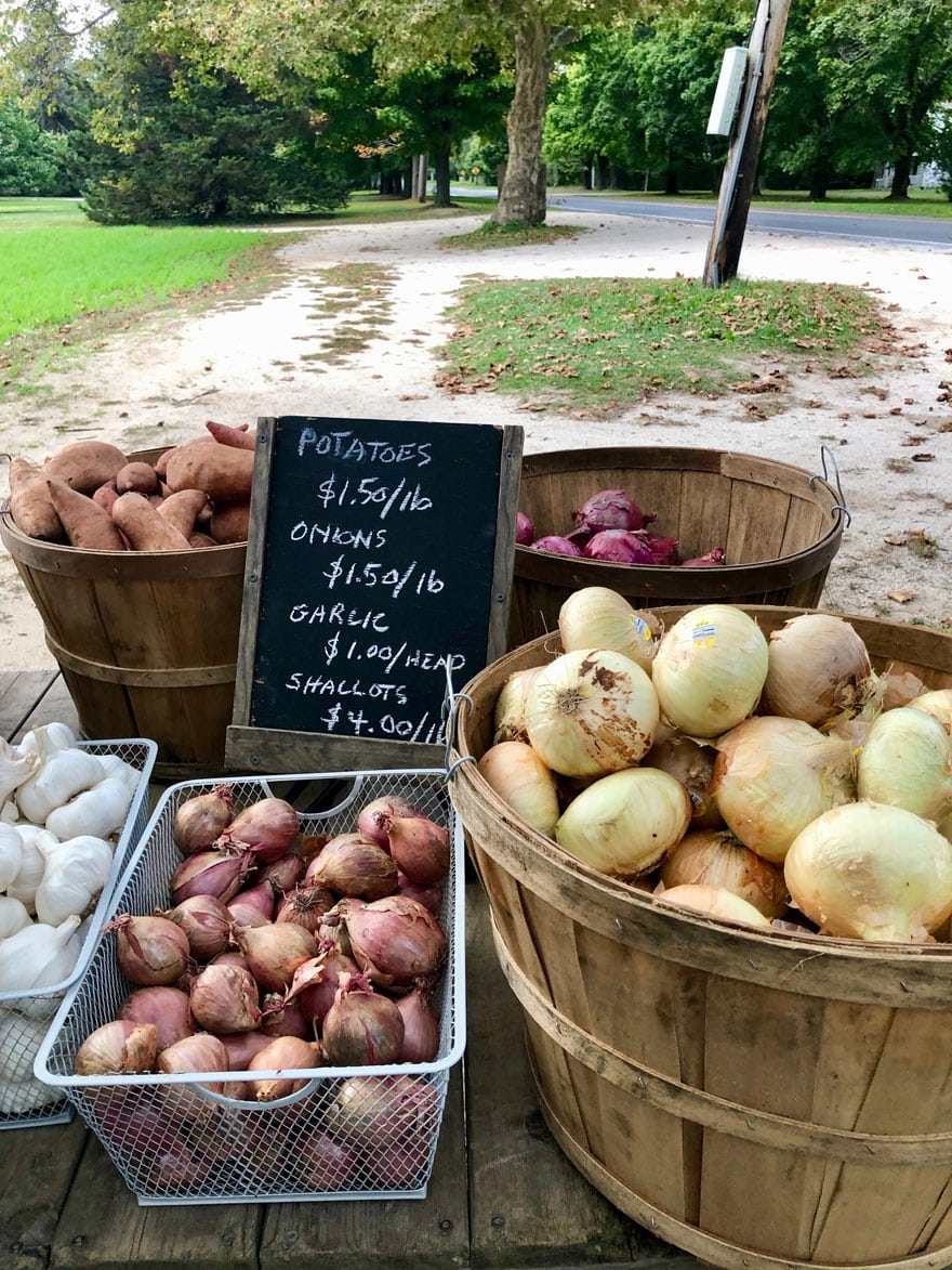 baskets of onions shallots at farm stand