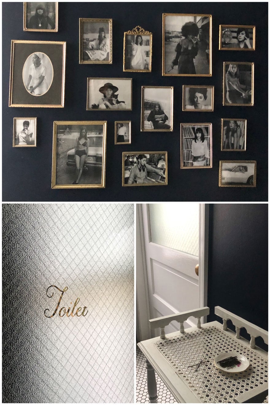 toilet on glass frsoted door, photos on black wall, dish of bobbypins