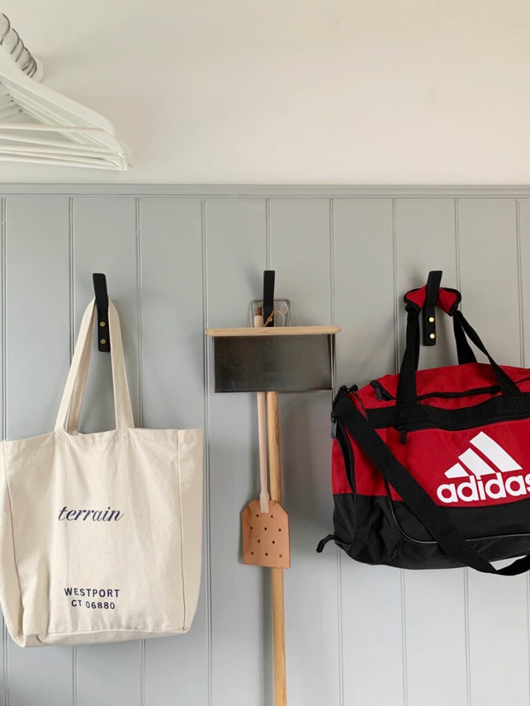 gray wall with red gym bag, dustpan