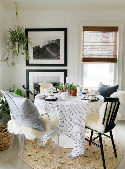 plants, round table with chairs and pillows and throws.