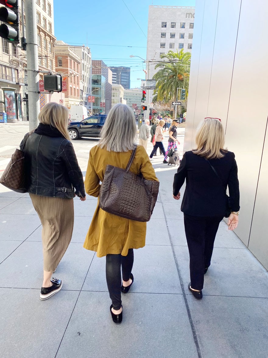 3 women walking from black in san Francisco 