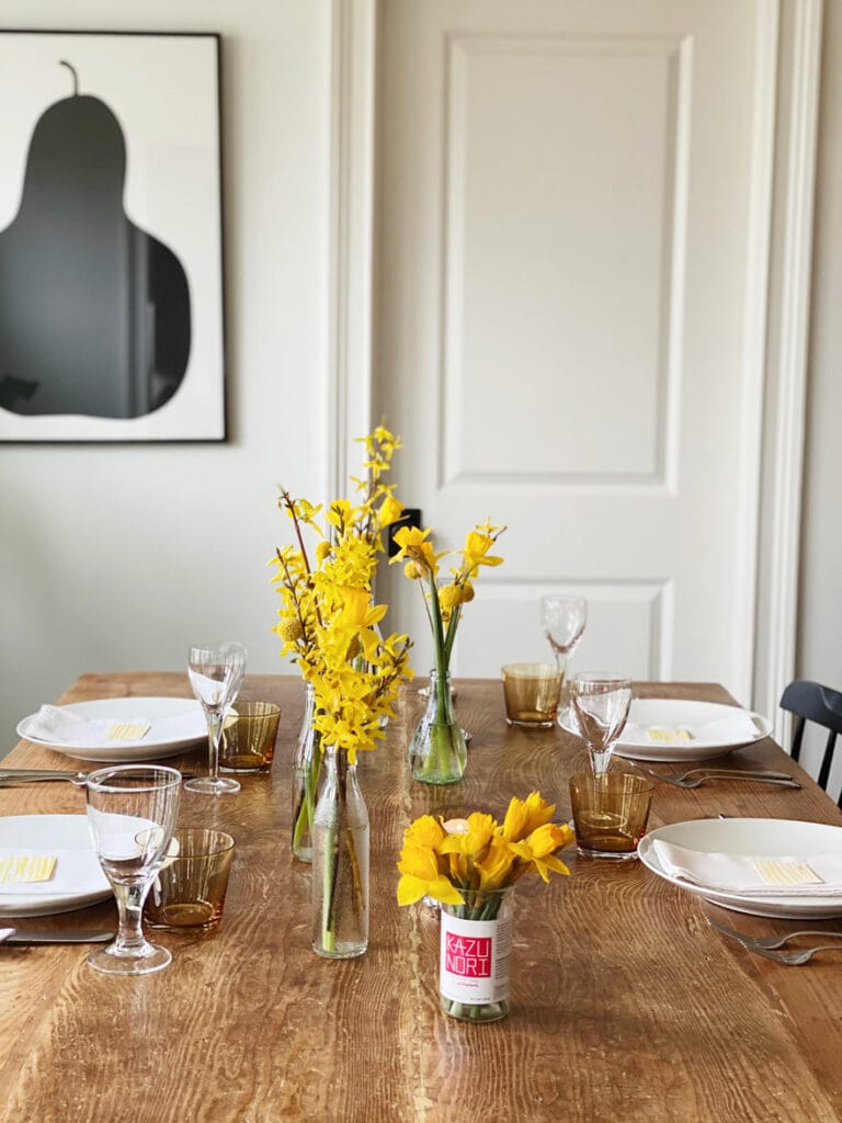 flowers on table with white dishes