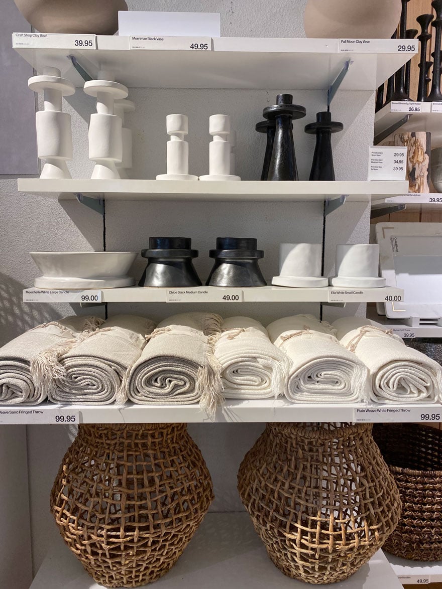 candlesticks, vases, basket on white shelves