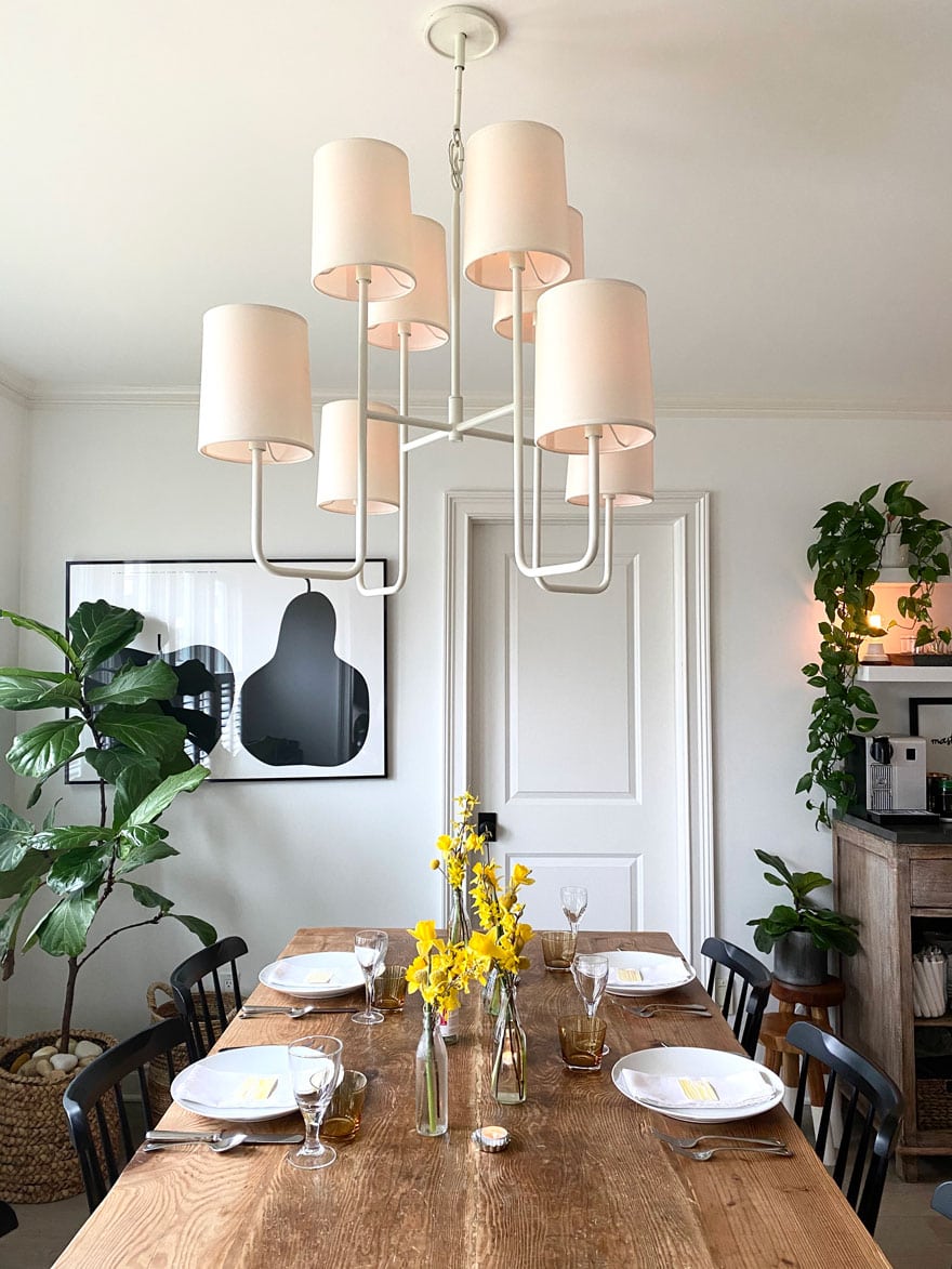 dining room with farm table, flowers, pendant