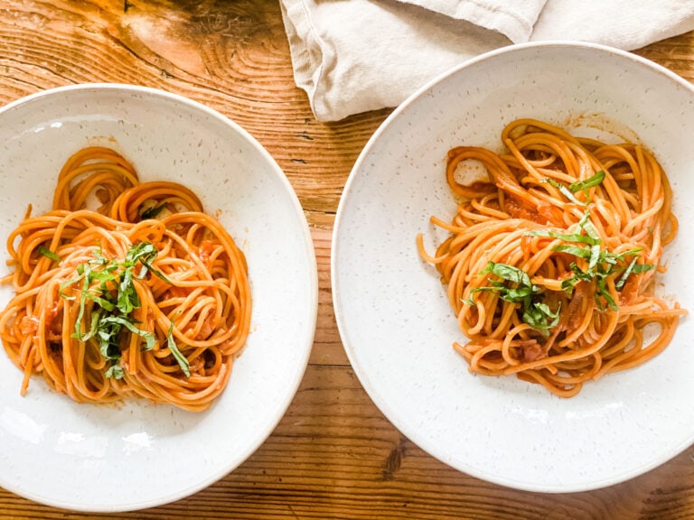 2 bowls of pasta with basil chiffonade