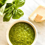 dish of basil pesto with basil leaves and cheese