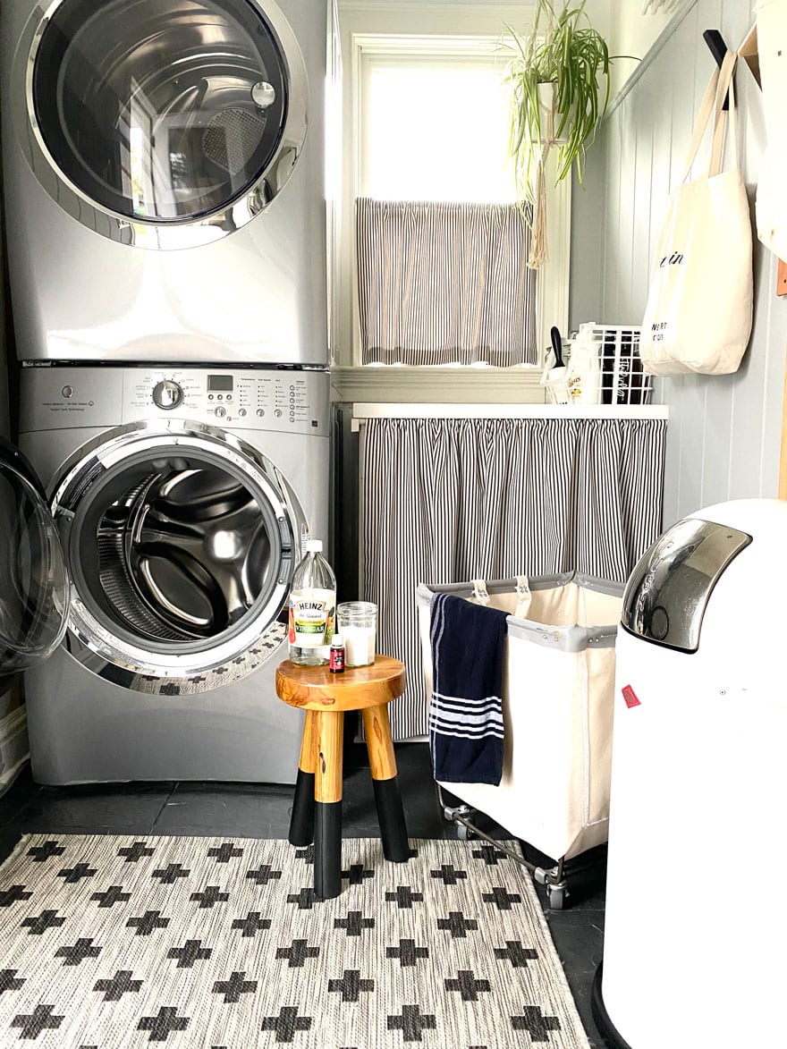 stool with vinegar, jar, oil, next to washing machine