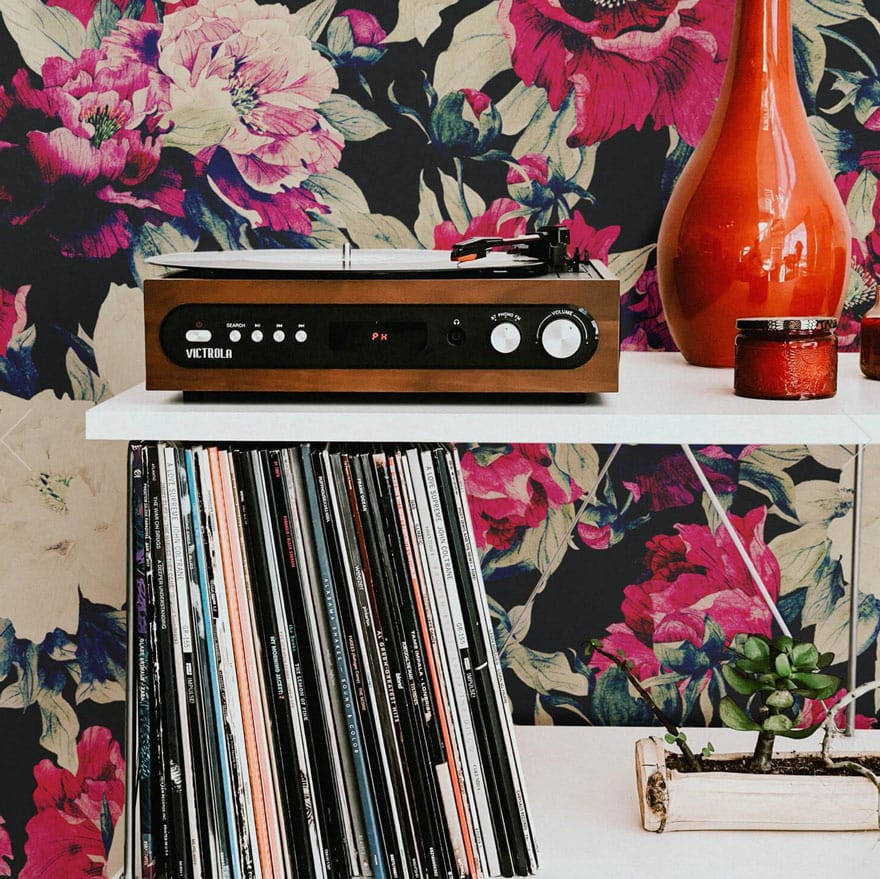 brightly colored wallpaper with record and red vase, candle in jar, record player