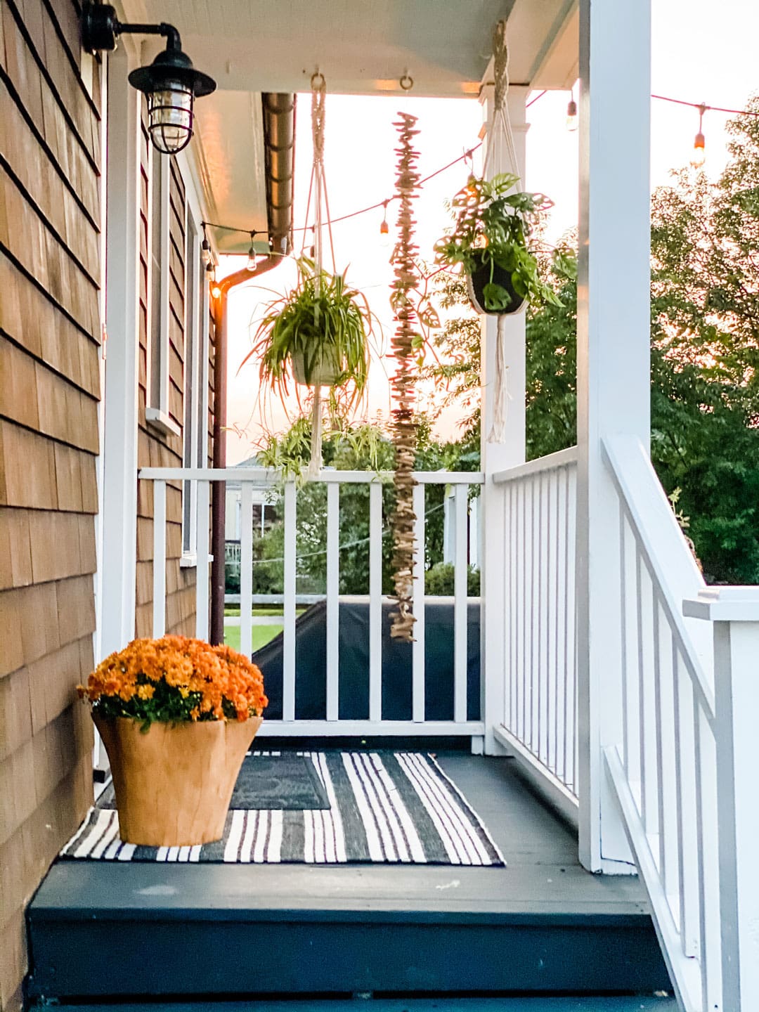 Lifestyle blogger Annie Diamond shares her simple fall decor on her back porch of her 1920s beach cottage in New England.