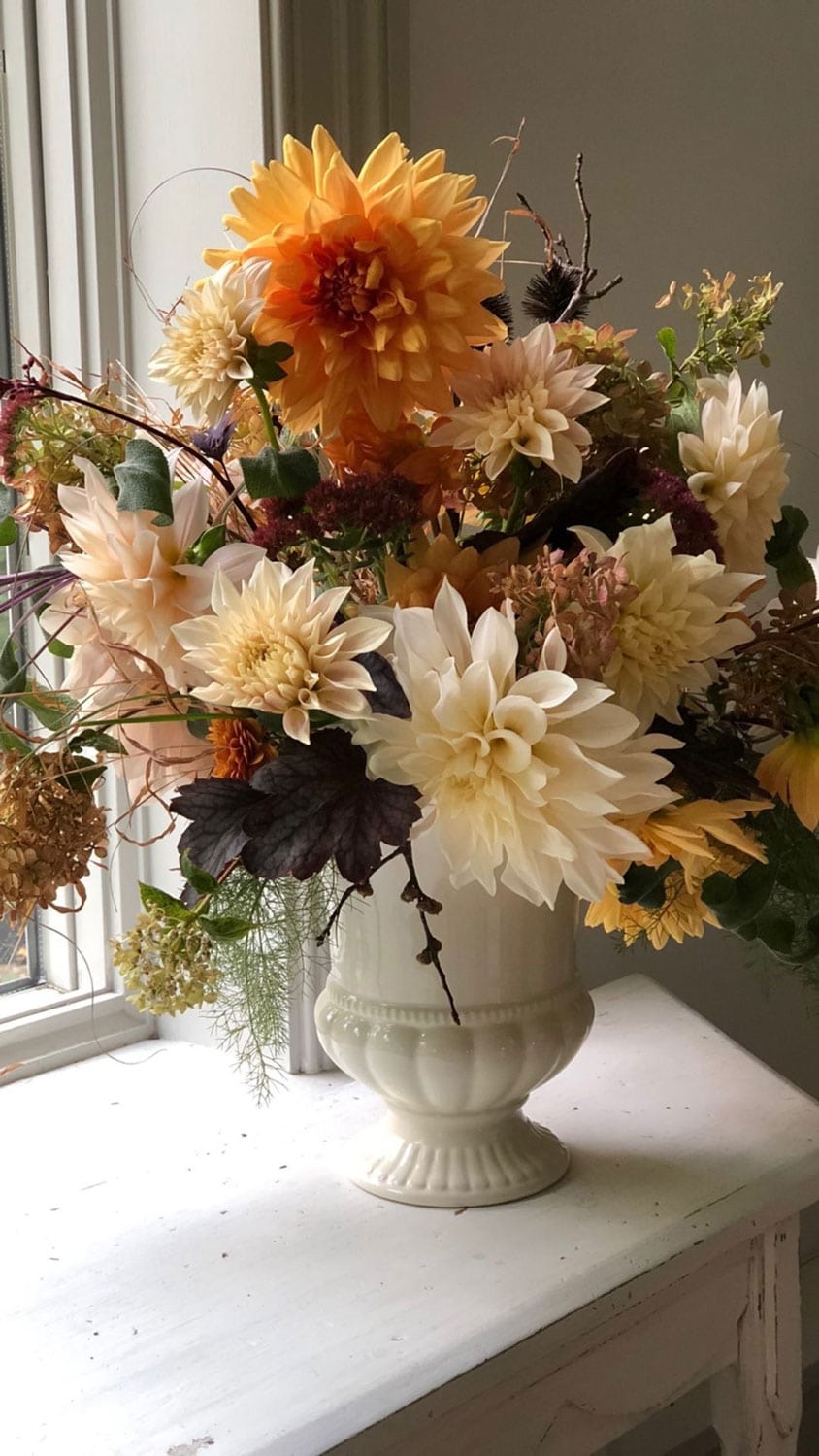 dahlias and foraged flowers in a vintage vase