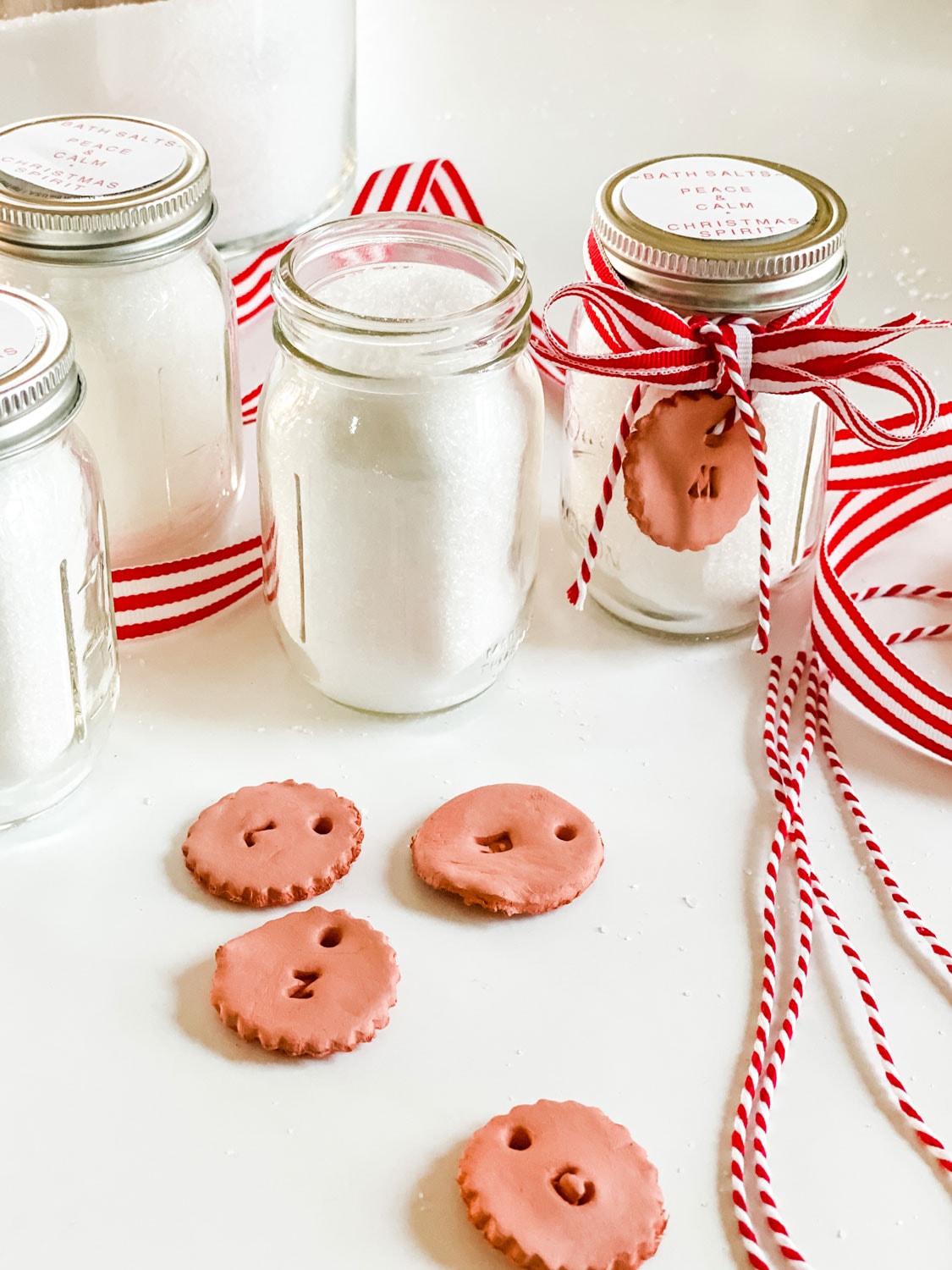 mini mason jar with bath salts and red and white ribbon and clay tag with twine