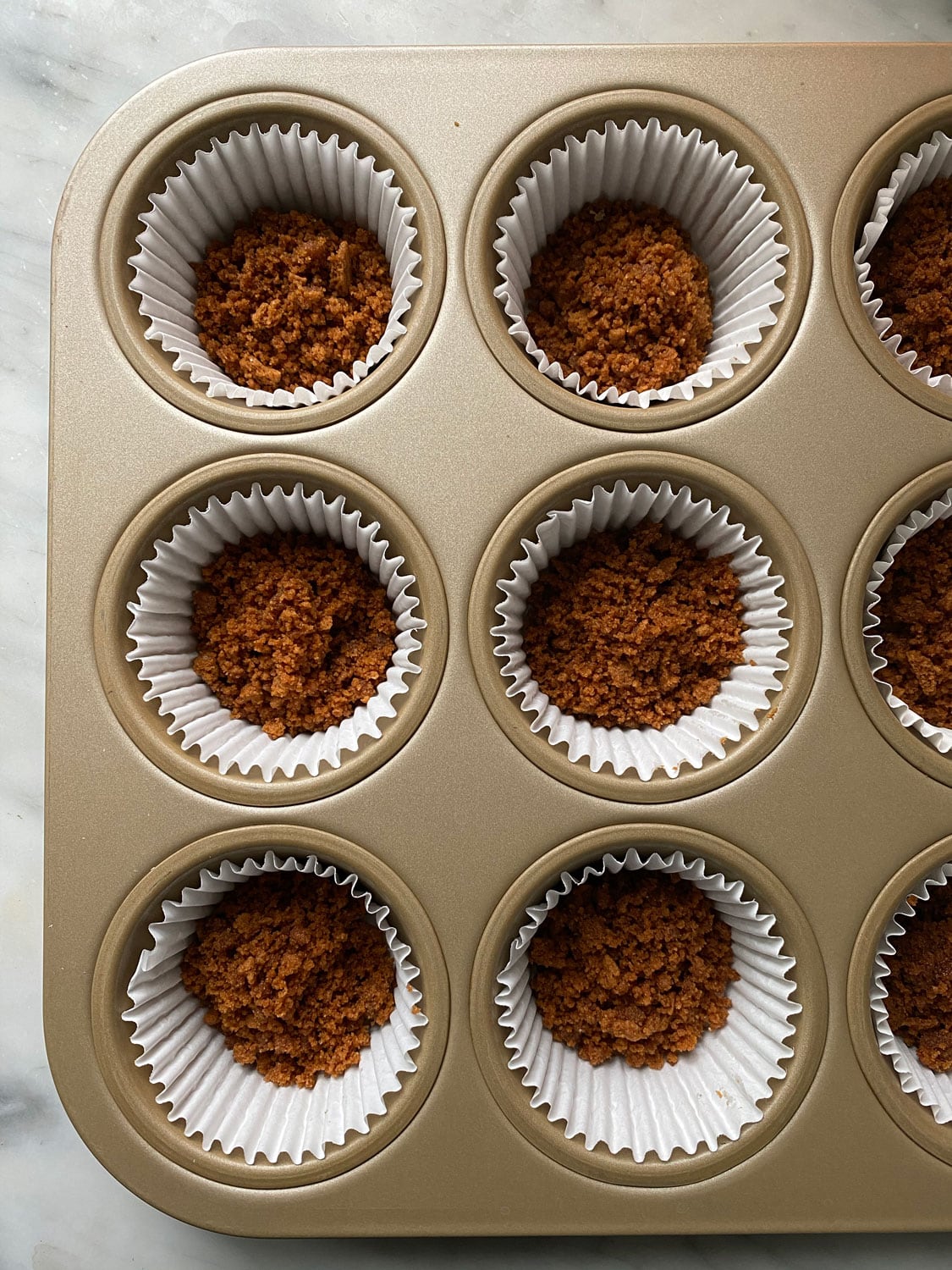 https://mostlovelythings.com/wp-content/uploads/2020/11/speculoos-crust-in-cupcake-liners-mini-pumpkin-pies.jpg