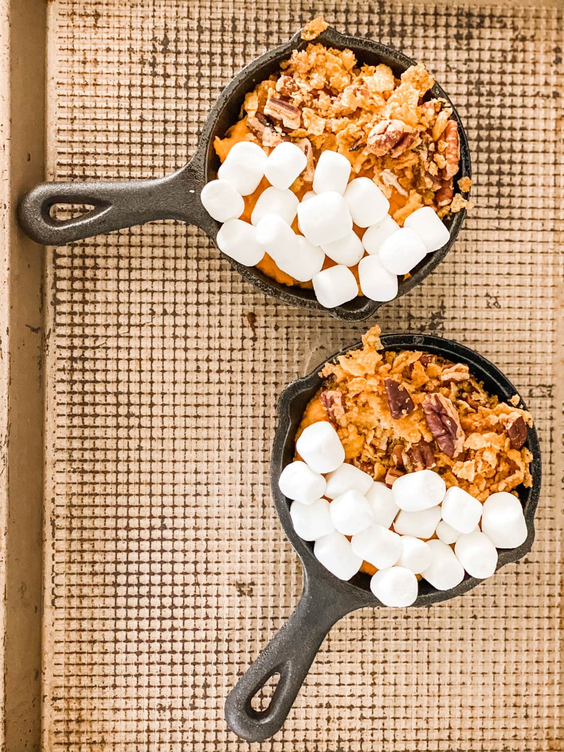 mini lodge skillets with sweet potato filling and topping on half and marshmallows on the other half