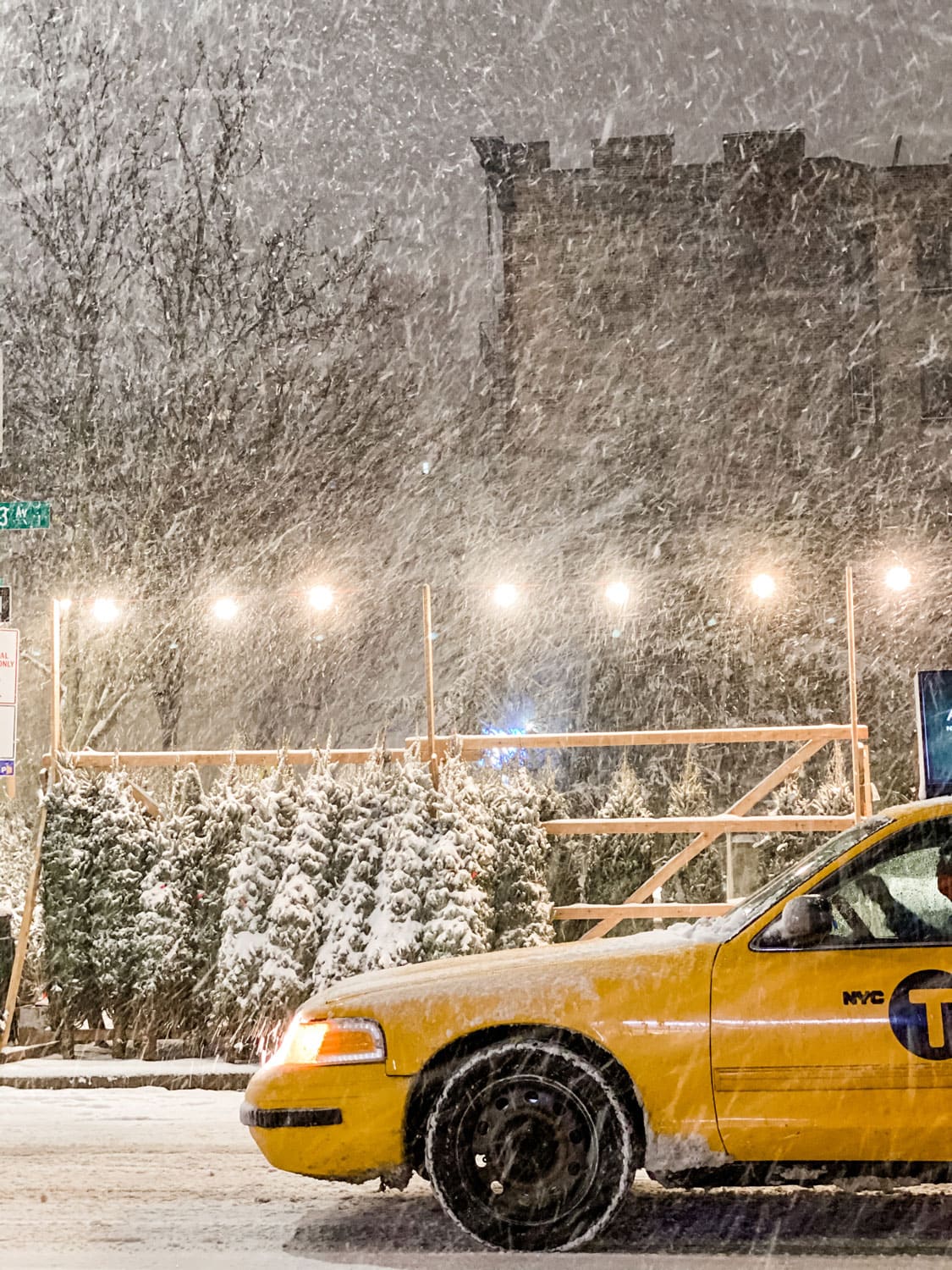Lifestyle blogger Annie Diamond take in Christmastime in New York...a yellow taxi driving by a sidewalk tree stand in a snow storm feels slightly magical. 