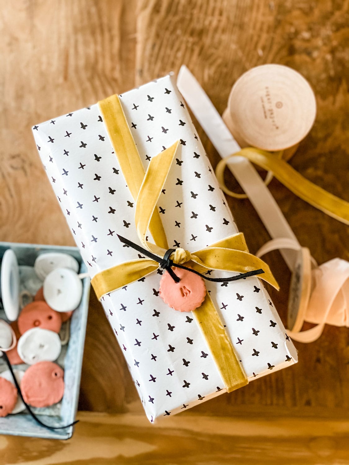 Gift wrapped with black and white paper and gold ribbon