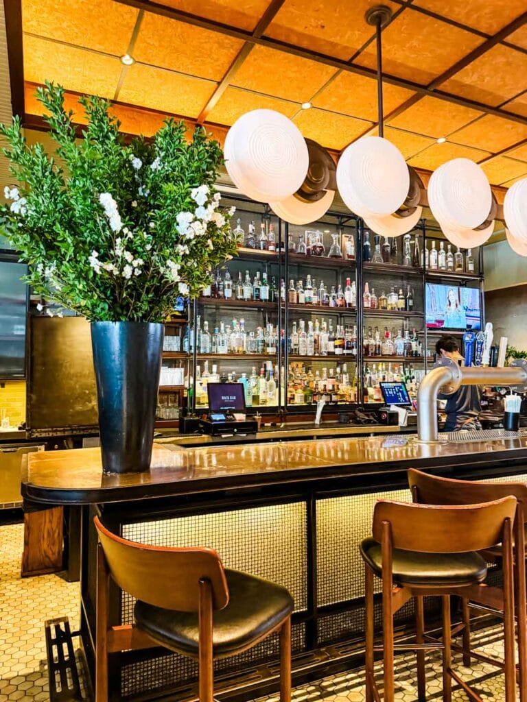 The bar with bar stools is at the entrance of the Back Bar in the Kimpton Hotel is a great spot for a cup of coffee.